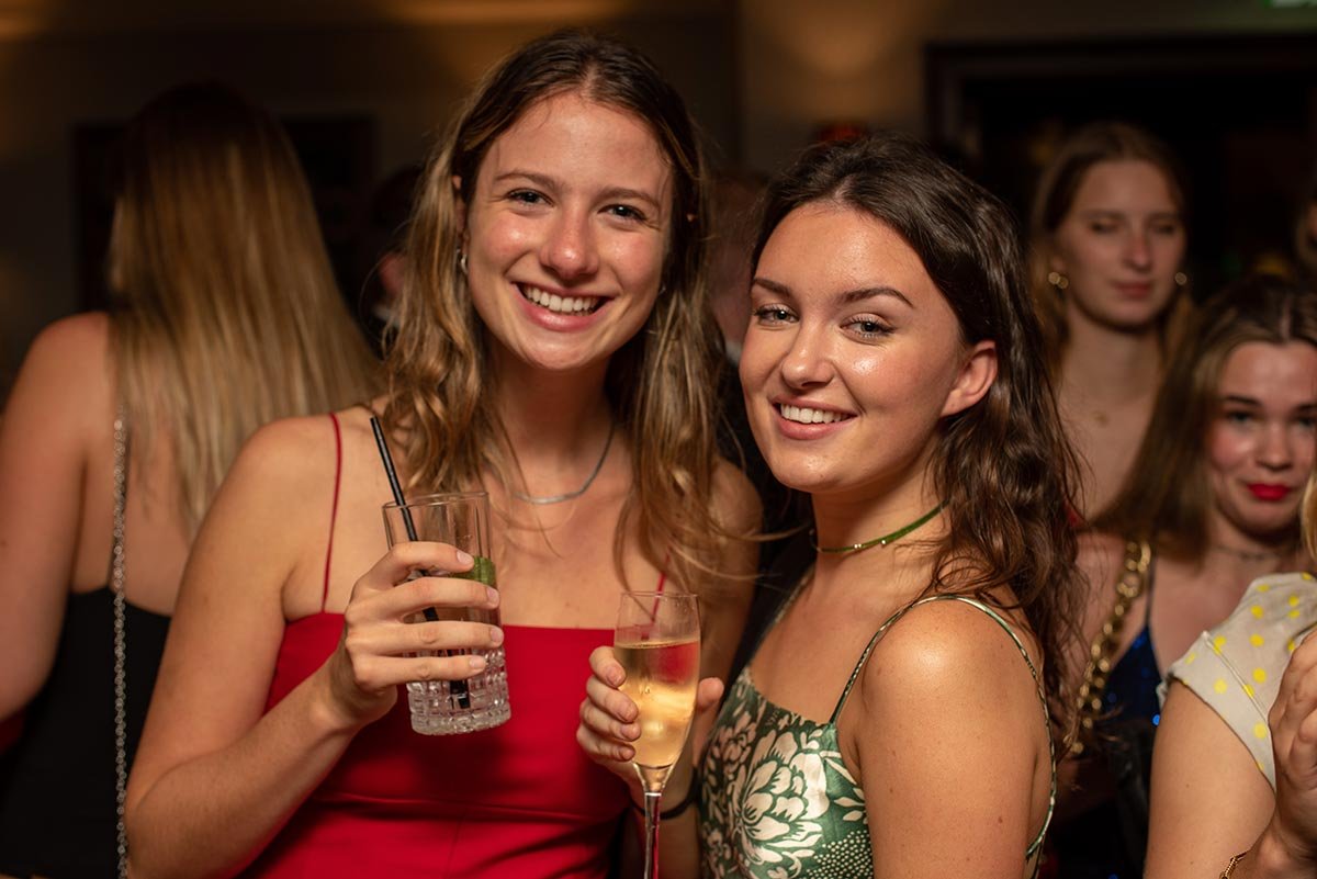 Guests laughing at a Cambridge event