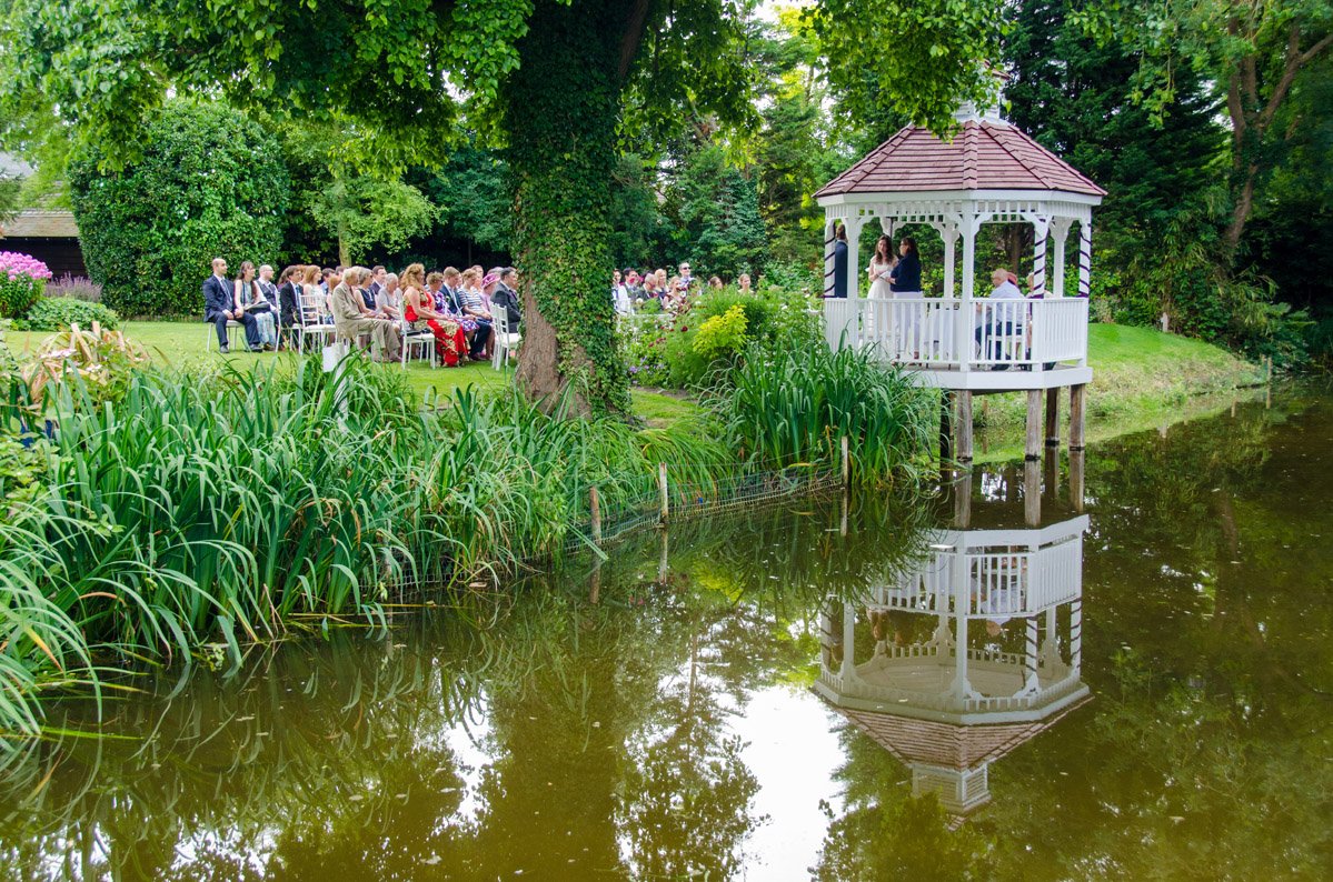 Wedding couple walking together in a historic brick lane