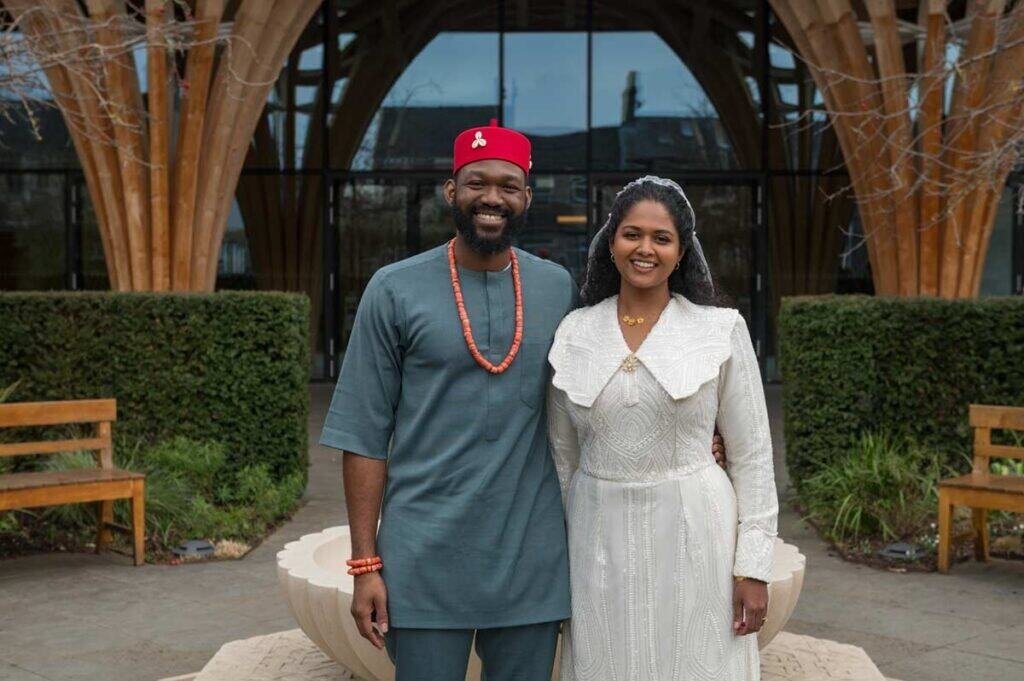 Smiling couple in traditional attire at cambridge photography session.