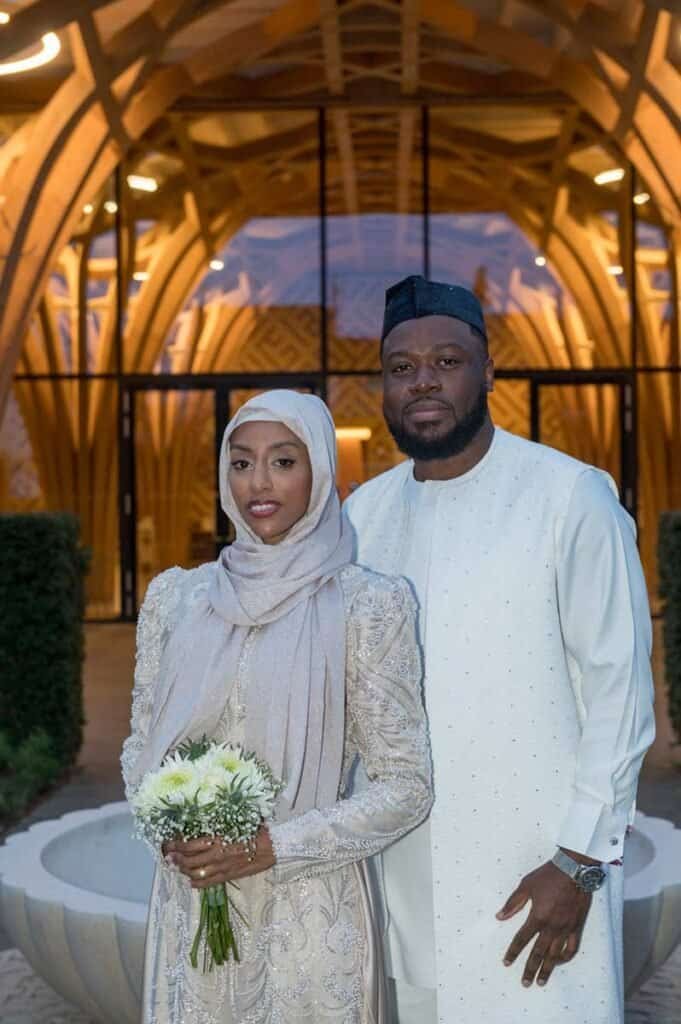 Beautiful couple in traditional attire at cambridge landmark.