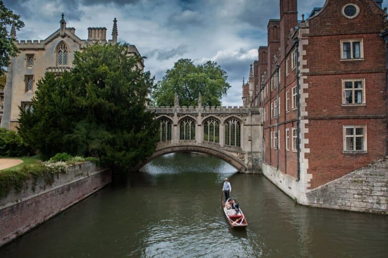 Cambridge wedding venues — couple portrait on a punt outside historic college