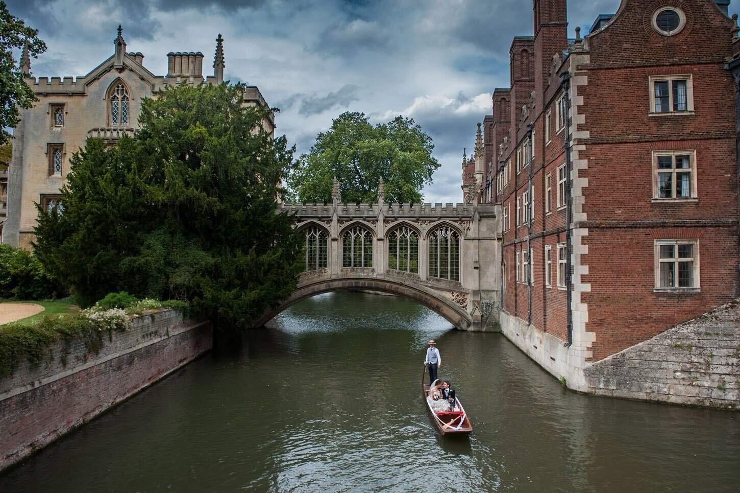 Cambridge wedding venues — couple portrait on a punt outside historic college